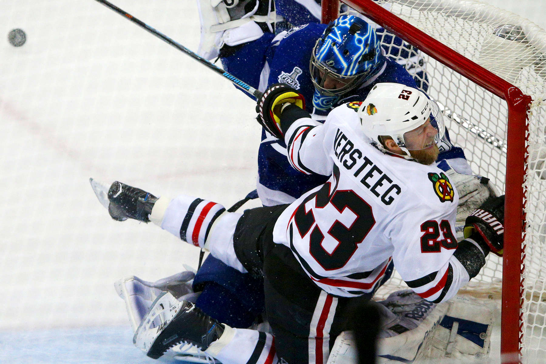 Chicago Blackhawks right wing Kris Versteeg collided with Tampa Bay Lightning goaltender Ben Bishop and the post after getting tripped up during the second period in Game 1 of the Stanley Cup Final at Amalie Arena in Tampa, Fla. 