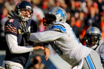Chicago Bears quarterback Jay Cutler took a hard hit from Detroit Lions defensive tackle Jermelle Cudjo after completing a pass in the third quarter of an NFL game at Soldier Field in Chicago. 
