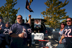 Bears fan Marc Sokolowski of Orland Park, at left, led a cheer with a poster of former Bears coach Mike Ditka in the tailgating area prior to an NFL football game against the Buffalo Bills at Solider Field in Chicago.
