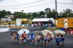 Audience members for the 2021 Little Miss Newville pageant wait out a rainstorm during the 61st Annual Newville Community Fair at the Newville Fairgrounds in Newville, Pennsylvania on July 7, 2021. A fundraiser hosted every year by the Newville Lions Club, the fair charges no admission or parking fees, generating funds from on-site sales and donations from participants. During the year, these funds help support local organizations and events.