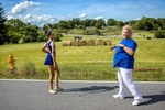 Katie Gaffigan (left) receives coaching from Donna Landsperger before performing with her twirling squad, the Catocin-Aires Twirling and Color Guard Corps, before the start of the Emmitsburg Community Heritage Day Parade in Emmitsburg, Maryland on June 26, 2021. Gaffigan was named and crowned queen of the group for 2021. 