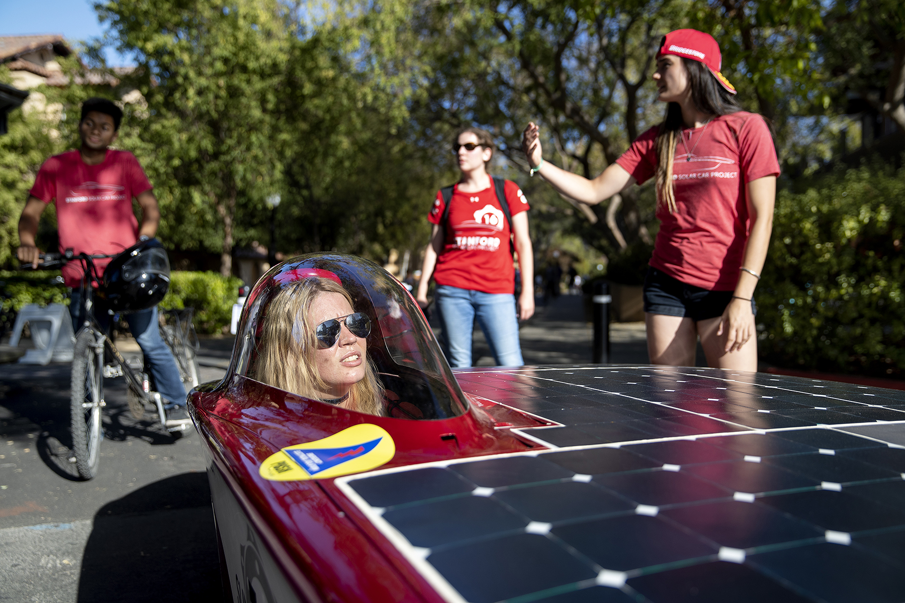 Maggie Ford, engineering director of the Stanford Solar Car Project, demos a solar car with her team at a September activities fair at Stanford University in Stanford, Calif., on September 28, 2018. Every two years, the student team designs, builds and races a solar car in the Bridgestone World Solar Challenge across the Australian Outback. Stanford University has had a large influence on the development of Silicon Valley. 