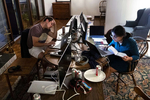 Drew Soldini (left) and Harshita Arora work for Do Not Pay on the beta version of an app to automate 12 big areas of the law at a home in Palo Alto, Calif., on August 15, 2018. Do Not Pay, which originally started as a chatbot to fight parking tickets, is working toward the goal of making the law free for all. The house, their temporary office at the time, is the same home Mark Zuckerberg rented in the summer of 2004 and served as Facebook's headquarters that summer.