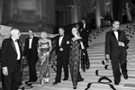 Guests of the San Francisco Ballet Opening Night Gala descend the stairs of City Hall while making their way from dinner to the performance in San Francisco, Calif., on Thursday, January 19, 2012. The galas are often all night affairs consisting of a cocktail hour, dinner, performance and an after party. These elaborate events give participants a chance to dress up, mingle with one another and generally see and be seen.       This photograph is of a candid moment and was not directed in any way. 