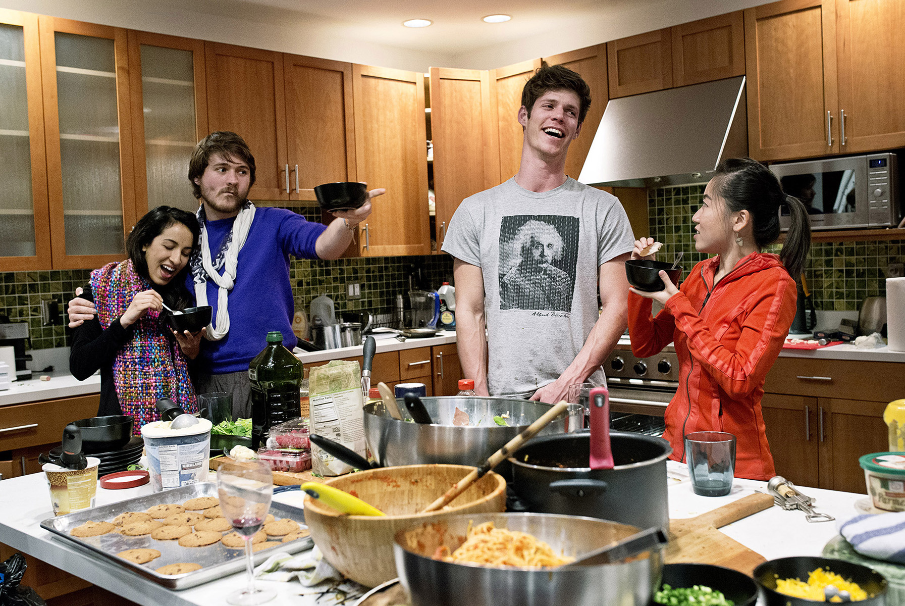 Noor Siddiqui, Conor White-Sullivan, Dylan Enright and Karen X. Cheng, seen left to right, eat dessert during a dinner party hosted by the company WeFunder at their office in San Francisco, California in February 2015. WeFunder is a crowdfunding service that connects start-ups and investors through the internet. The company and it’s founders throw large dinner parties almost every Wednesday for friends and guests from the industry at their office, which also serves as the home of several company employees.