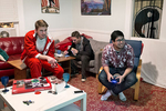 Sean Ross (left) plays video games with his housemate Bastian Ermann while hanging out in the common room at 20 Mission with Henri Roussez (center) in San Francisco, Calif., on Saturday, December 13, 2014. The co-living house is home to around 45 people, many of whom are entrepreneurs or working in the tech industry. Most of the residents have their own room, but share the common room, one kitchen and two bathrooms. 