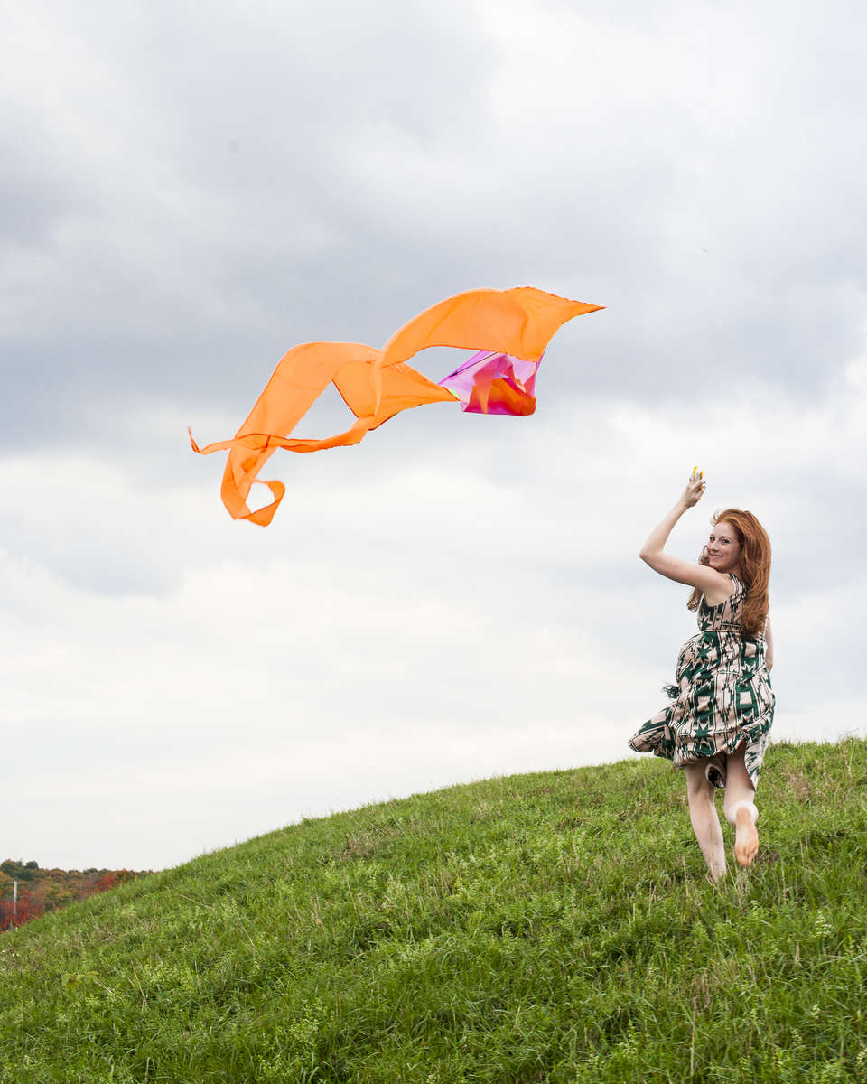 Woman flies a kite in the fall on a Shelburne hilltop. by Vermont photographer Judd Lamphere