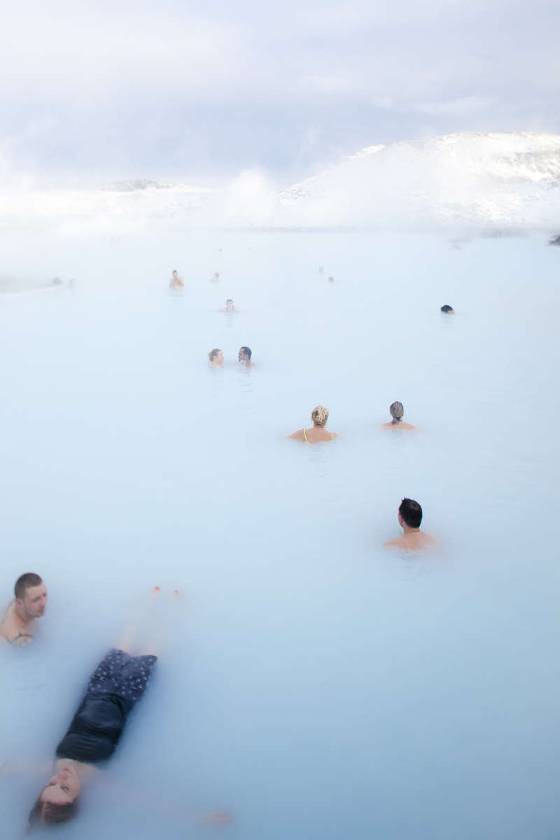 Tourists and visitors floating in Blue Lagoon waters in Iceland, by Vermont photographer Judd Lamphere