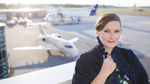 Portrait of woman in front of airplane  by Eve Event Photography