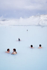 Visitors swim in the Blue Lagoon, a spa and major tourist attraction in Grindavik, Iceland. The Svartsengi geothermal power plant\'s waste water, after passing through a heat exchanger to provide municipal hot water, is fed into the Blue Lagoon.