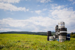 Kegs of beer in a field in Greensboro, Vermont near Hill Farmstead Brewery. by Vermont photographer Monica Donovan.