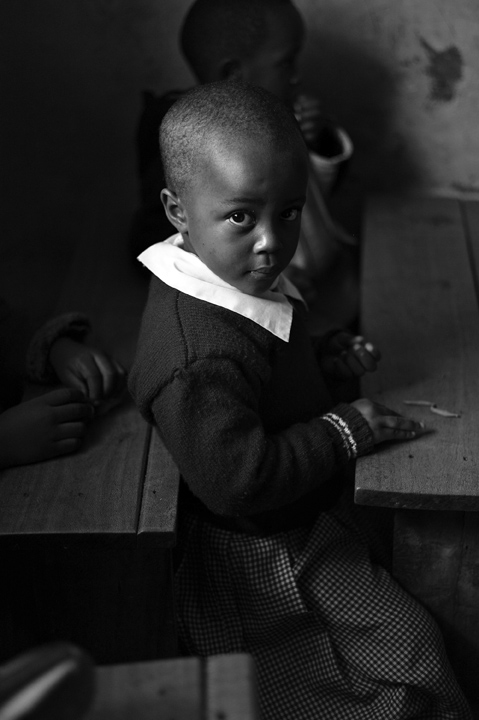 Ebsen Onyango, 4-1/2-yrs. old sits at her desk during class.