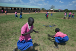 Students play during their lunch break at Acutomer Primary School. The school does not provide meals to the students so because many of them live too far to go home for lunch they don't eat. 