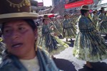Folkloric groups and dancers march through the streets in celebration of La Festividad de Nuestro Senor Jesus del Gran Poder. It began in 1939 as a candle procession proceeded by an image of Christ. It has evolved into a large celebration honoring the Aymara culture.