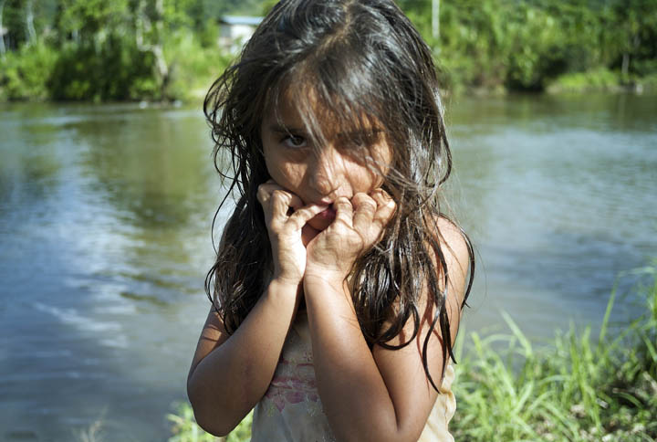 An Amazonian girl, Luz Yovani Villa Pena, 10, dries off in the sun after playing with friends in the Chiriaco river. 