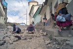 Workers use rocks to pave the streets of this north Yungas community.