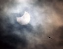 A partial solar eclipse occurs with the moon shielding 35 percent of the sun.