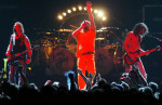 Members of Van Halen, Sammy Hagar, center, Eddie Van Halen, right, and Michael Anthony perform Aug. 19, 2004.