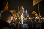 November 16,2015 - Germany, Saxony, Dresden : A demonstrator holds a illuminated cross as he takes part in the demonstration of about 10.000 Supporters of the Pegida movement at their weekly Monday gatherings. Demonstrators shout slogans as: 'Merkel muss weg (Merkel has to go). Pegida is an acronym for 'Patriotische Europaeer Gegen die Islamisierung des Abendlandes,' which translates to 'Patriotic Europeans Against the Islamification of the Occident' and has quickly gained a spreading mass appeal by demanding a more restrictive policy on Germany's acceptance of foreign refugees and asylum seekers. Parts of this  right-wing movement are also against the Euro and the Western liberal style of living in general. The first Pegida march took place in Dresden in October 2014 and has since attracted thousands of participants to its weekly gatherings. But it turned out that even after the Paris attacks last Friday  that left at least more 120 people dead Pegida was not able to show up in larger numbers as in the weeks before the terrorist attacks. 