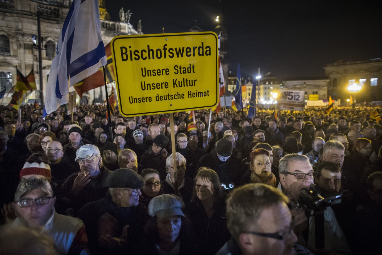 November 16,2015 - Germany, Saxony, Dresden : Demonstrators  hold  placards that read the names of the small Saxon villages they are coming from as they  take part in the demonstration of about 10.000 Supporters of the Pegida movement at their weekly Monday gatherings. Demonstrators shout slogans as: 'Merkel muss weg (Merkel has to go). Pegida is an acronym for 'Patriotische Europaeer Gegen die Islamisierung des Abendlandes,' which translates to 'Patriotic Europeans Against the Islamification of the Occident' and has quickly gained a spreading mass appeal by demanding a more restrictive policy on Germany's acceptance of foreign refugees and asylum seekers. Parts of this  right-wing movement are also against the Euro and the Western liberal style of living in general. The first Pegida march took place in Dresden in October 2014 and has since attracted thousands of participants to its weekly gatherings. But it turned out that even after the Paris attacks last Friday  that left at least more 120 people dead Pegida was not able to attract larger crowds  as in the weeks before the terrorist attacks. 