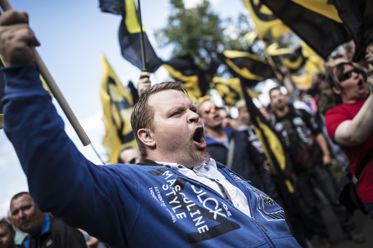 June 17, 2017 - Berlin, Germany: Supporters of the Identitarian Movement shout slogans and wave flags as they  march  on Brunnenstrasse in Wedding district.  The Identitarian Movement originated in France and with its ideology of a racially-based concept of European identity has drawn right-wing supporters across Europe. The movement has positioned itself against the acceptance of Muslims and Islam in Europe and has also sought to stop immigration from non-European nations.