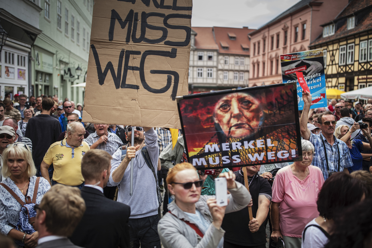 August 26, 2017 - Quedlinburg: Protestors of the Neo Nazi and right wing political  spectrum like the AfD, NPD and the Identitarian movement protest during German Chancellor and Christian Democrat (CDU) Angela Merkels speech  at an election campaign stop in Quedlinburg, Germany. Merkel is seeking a fourth term in federal elections scheduled for September 24 and she currently holds a double-digit lead over her main rival, German Social Democrat Martin Schulz.(Hermann Bredehorst / Der Spiegel / Polaris)