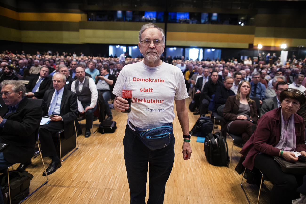 April 30, 2016 - Germany, Stuttgart: A man wears a t-shirt that reads: Democracy instead of Merkulatur as he joins about 2000 registered members that attend the party congress of the right-wing party Alternative für Deutschland (AfD). The rapidly growing party is expected to adopt an anti-Islamic manifesto, emboldened by the rise of other European anti-migrant groups like Austria's Freedom party. 