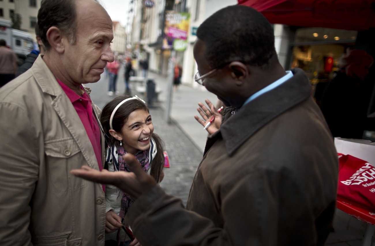 A young girl and her father react as they chat with Senegalese born Karambe Diaby , Social Democratic candidate for the German Parliament, while on the campaign trail in his constituency in Halle/Saale. Diaby, a PhD in chemistry, canvassed the former hub for East Germany's chemical industry to become the first black member of the Bundestag in German history. 