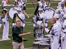 Drum Judge hands back the shanko of a drummer from Phantom Regiment at the 2015 DCI Finals at Lucs Oil Stadium. Photo by ronwyattphotos.com