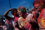 Revelers threw pigment powder at each other for the celebration of Holi during the annual Phagwah Parade in Richmond Hill, Queens 