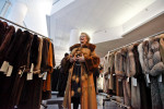 Mirian Segal, from the Upper East Side, tries on fur coats as  at the annual Lighthouse sale