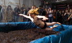 A man dives in at the begining of an underground mud wresteling competition held in Bushwick, Brooklyn
