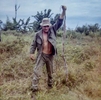 John Patrick Phelan holds a dead cobra snake just over 6 feet in length.
