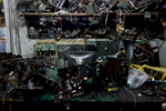 In Victor Arevalo's shop, it costs about $8 USD to repair a CRT TV. Repair shops purchase or hoard components from used TVs to fix their customers' products. Used parts are no longer available from the original manufacturer. Images such as these are often used to demonstrate the environmental hazards of electronic scrap flows, but closer inspection confirms that the space is, well, just messy. Though the components are strewn everywhere, they are simply inventory. 