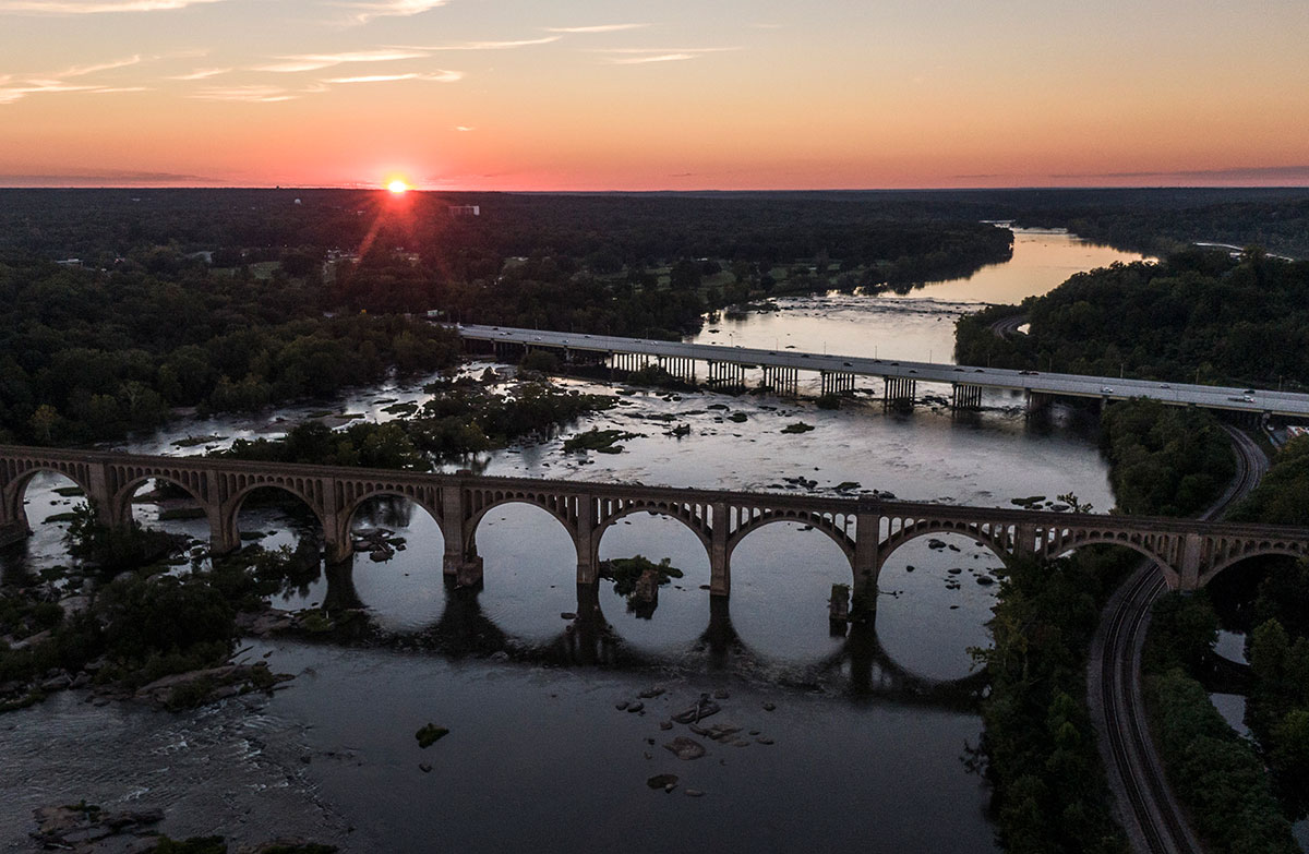 James River Railway Bridge, also known as the CSX A-line bridge, is one of picturesque places in Richmond over the James River and its images are often used for posters, postcards, T-shirts, and so on to illustrate the beatify of the river. The bridge, which designed by John E. Greiner and built in 1919 for the Richmond, Fredericksburg and Potomac Railroad, is now part of CSX lines and located between the Powhite Parkway, shown in this drone photo on the background, and the Boulevard Bridge(The Nickel Bridge). Sunset over this arched bridge on James River is one of magnificent views that Richmonders are fortunate to have. 