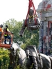 The top part of Robert E. Lee statue is lifted on Monument Ave.