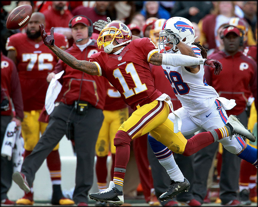 Washington Redskins' wide receiver DeSean Jackson(11) misses a pass against Buffalo Bills' cornerback Ronald Darby(28) as Redskins’ head coach Jay Gruden reacts to the action during the second half of NFL football game at FedExField.