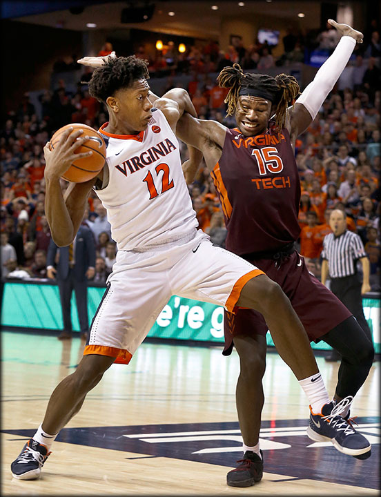 UVA's De'Andre Hunter(12) and Virginia Tech's Chris Clarke(15) get physical during the overtime of a NCAA men's basketball game at University of Virginia,