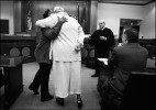 Jennifer gets a hug from a fellow addict when Judge H. Vincent Conway Jr. announces that Jennifer has graduated to a higher level in Drug Court. Gary Ford, right, applauds the promotion.