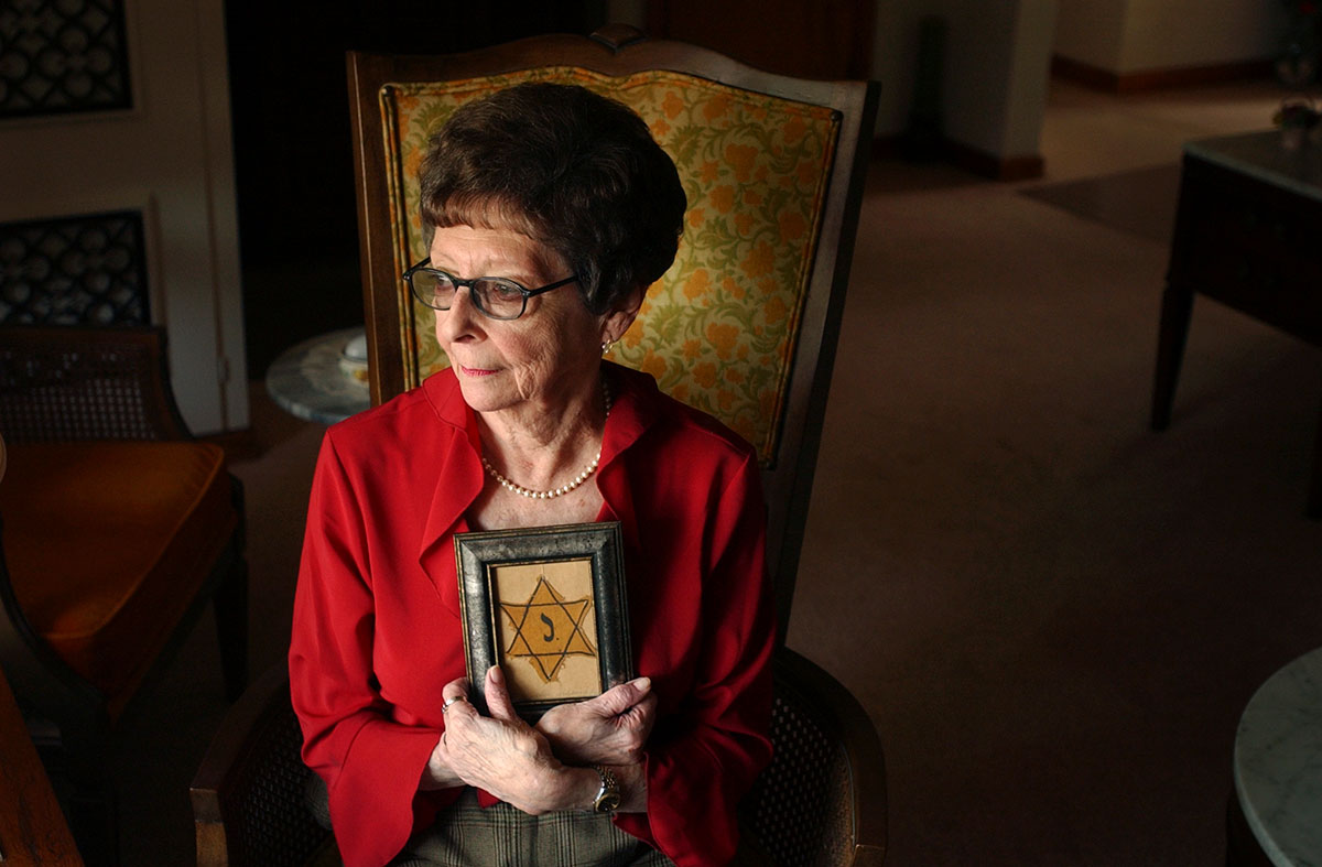 Kitty Saks holds a yellow star, which she was forced to wear on her clothes, designating her as a Jew during World War II. Saks survived the Holocaust by being hidden in seven convents in Belgium.