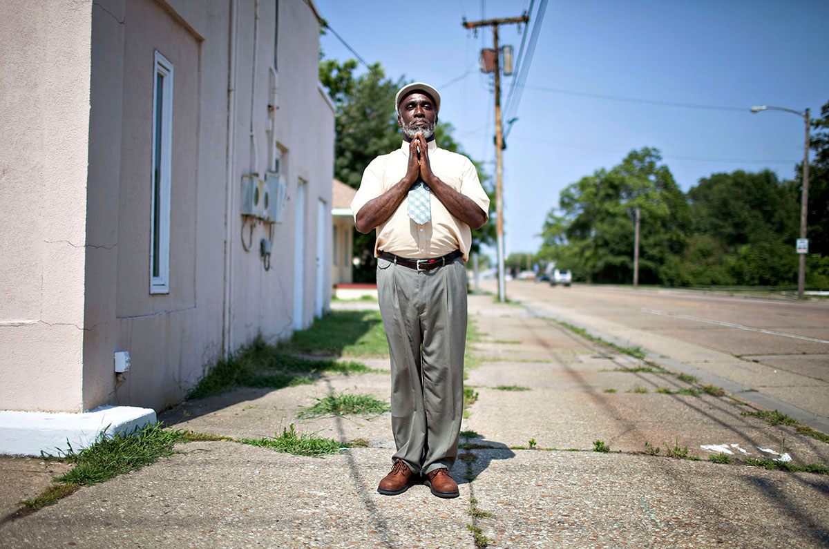 Lorenzo Pope, of Newport News, prays on the street in the hot summer day in Southeast Community in Newport News. Pope says of why he prays in the middle of street for last 30 years, {quote} I'm lived by the Holy Spirit, not my doing, not my will. It's God's will.{quote} 