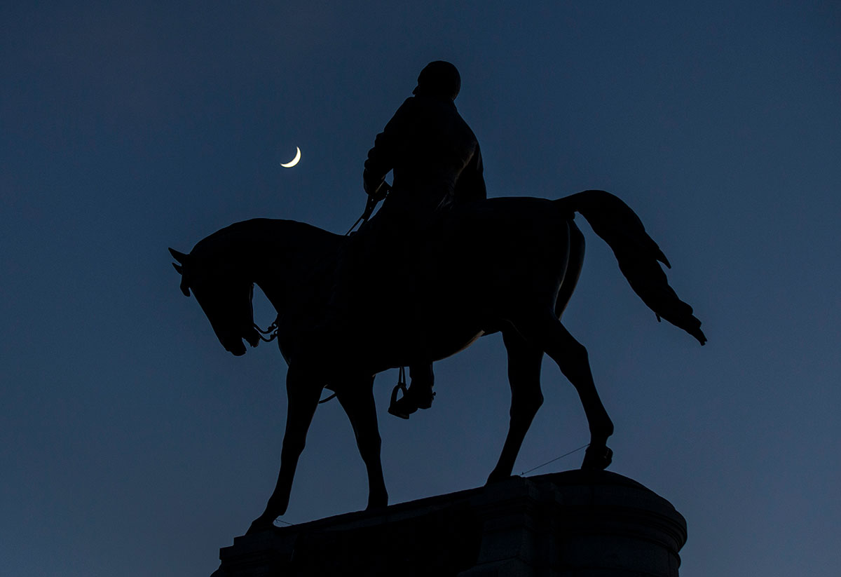 The crescent moon sets on top of Robert E. Lee Monument.