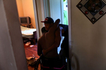 Dexter Tillery lifts up his cousin Edward Miller taking a shower. Simply using a bathroom for Edward is a challenging task for the family. “Everything now is much slower. You have to wait a lot of time on other people’s time,” Edward said of being helped on his daily activities. 