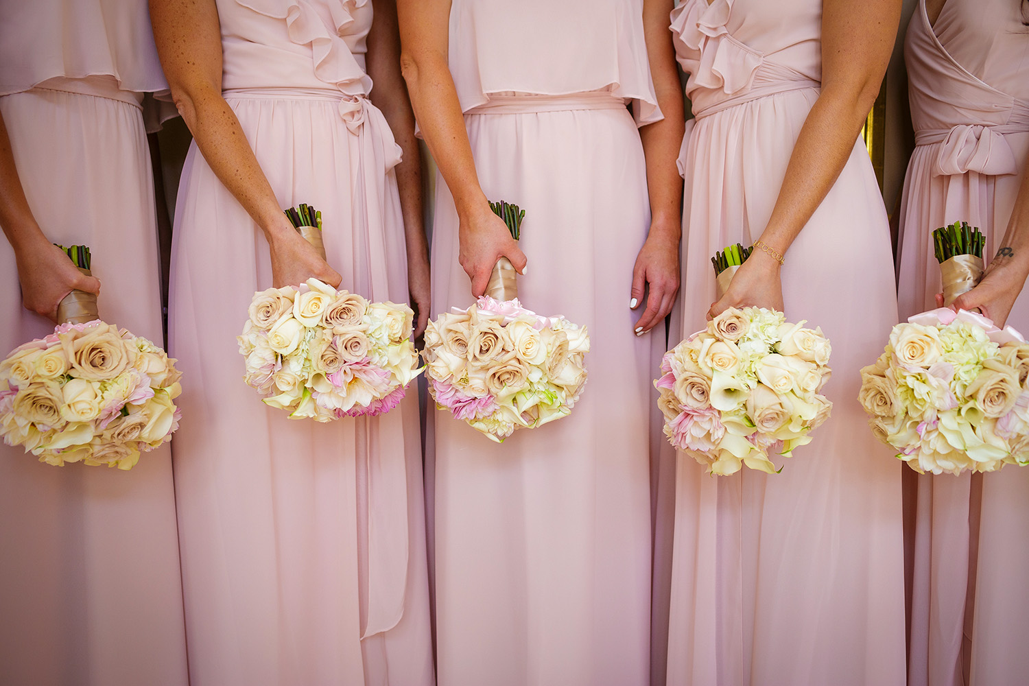 pink-bridesmaid-dresses-against-white-roses