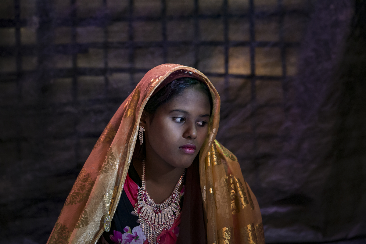  Farmina Begum, 16, is seen on the day of her wedding to 18 year old Hashimullah, in a Bangladesh refugee camp in Cox's Bazar, Bangladesh. Farmina and her family fled on August 25th after the military attacked their village of Kullung. The military came to their village and burned houses and shot people. They hid in the hills for 8 days and spent 5 days walking to the Bangladesh border. Hashimullah and Farmina met at the water pump in the Bangladesh refugee camp near their home and he proposed to her father and he agreed to the marriage. Farmina's mother says 'When we got his proposal we agreed because we don't enough food to feed her. If she got married, she would then be her husband's responsibility. She's getting older and and older girls shouldn't be single.' 