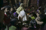 Women crowd around Nur Begum, who doesn't know her age but thinks she is between 14 and 16 years old, on the day of her wedding to Rayeed Alam, 20, in a Bangladesh refugee camp in Cox's Bazar, Bangladesh. Rayeed came to Bangladesh with his family shortly after the August 25th attack. He says the military attacked his village and shot people, burned houses and raped women. It took him 3 days to walk to the Bangladesh border. Rayeed's parents arranged the marriage because all of his sisters are already married and his mother needed someone to cook and look after her and her husband. Nur Begum said that her parents arranged the marriage for her and she had no choice in the matter. 