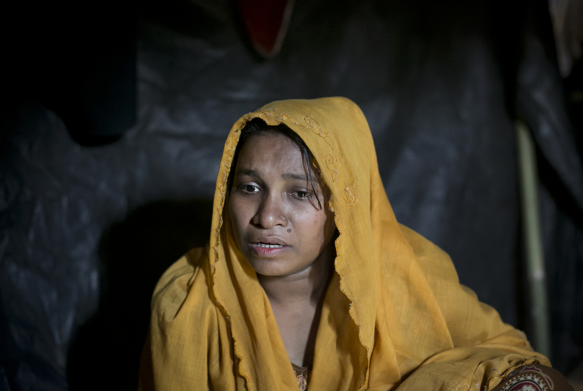 Fareza becomes emotional as she talks about being raped by the Myanmar military in her makeshift house that she shares with 6 other refugees in BaluKali Rohingya refugee camp in Cox's Bazar, Bangladesh. Fareza, 17, came to Bangladesh 3 days ago from Shilkhali village in Myanmar.  She describes a happy life in Myanmar until 4 months ago when the military began attacking and harassing people in her village. Last Monday, January 16, 2017, she says that a group of soldiers attacked her home and dragged her and her family out into the front yard and beat them with their fists and the butt of their guns. They groped her everywhere and dragged her back into her house where one soldier raped her until she lost consciousness. She woke up bleeding and decided to flee to Bangladesh, where she made her way to Balu Kali refugee camp. She is 6 months pregnant and has not been able to make contact with her husband back in Myanmar. {quote}For 4 months back in Myanmar I lived in a constant state of fear. At least here in Bangladesh I can sleep peacefully.{quote} 