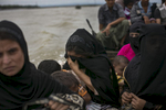 A Rohingya refugee, who's husband was killed by Burmese military, cries as she takes a boat to cross into the mainland after arriving in Bangladesh 