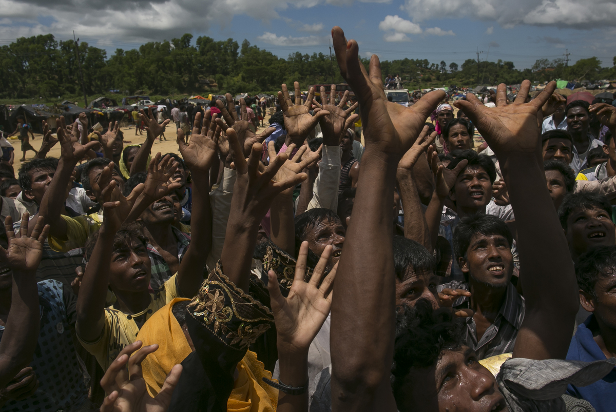 Rohingya receive donations in an informal settlement 