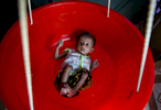 7 month old, 2.7kg Asufa, a Rohingya refugee, is weighed at an Action contre la Faim feeding center in Balukhali camp 